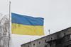 A Ukrainian flag flies in front of an apartment building that was damaged as a result of shelling by Russian troops in Borodianka