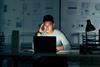 A man works on a laptop in the office