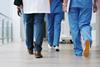 Hospital staff walk down the corridor